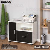 A black and white stepped mobile file cabinet with a lock and wheels, placed in a home setting with books and a cactus decor.